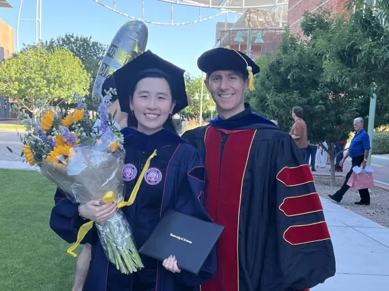 Linh and Ryan in regalia at the Genetics Graduation ceremony