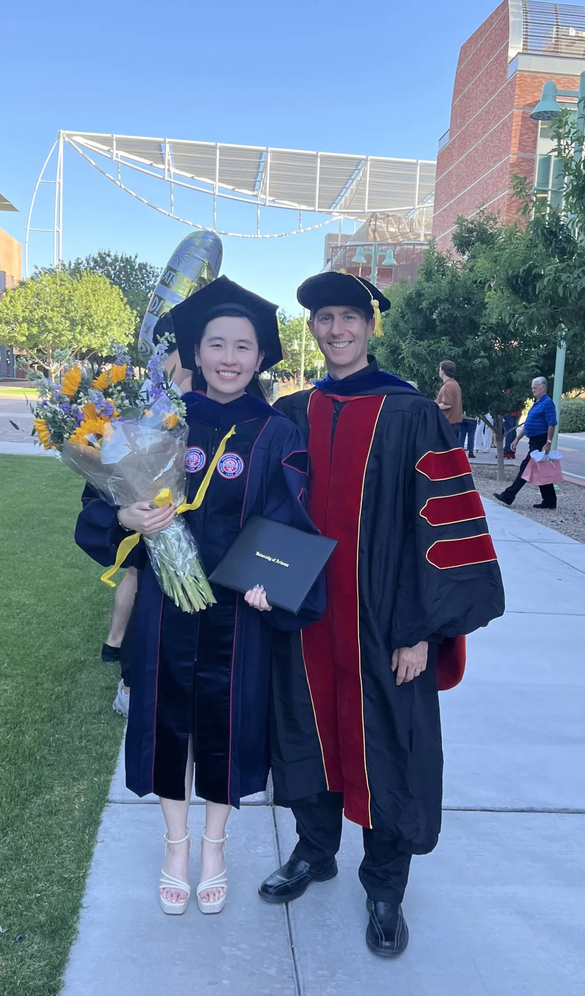 Linh and Ryan in regalia at the Genetics Graduation ceremony